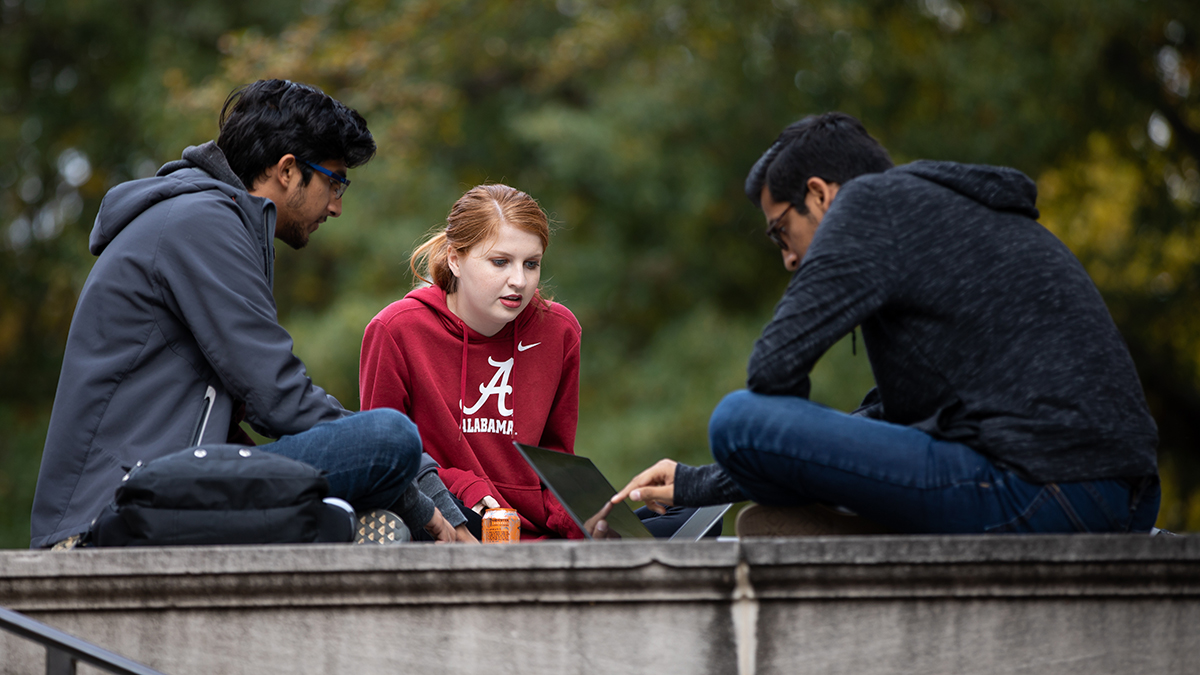 three students sitting on the Gorgas Library steps